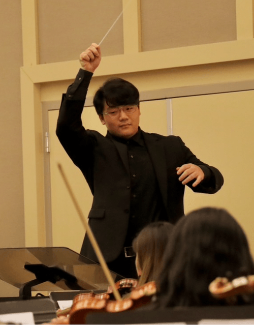 Aidan Chun Wielding A Baton